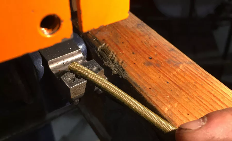 Hog-tie style staple installed onto bungee cord.