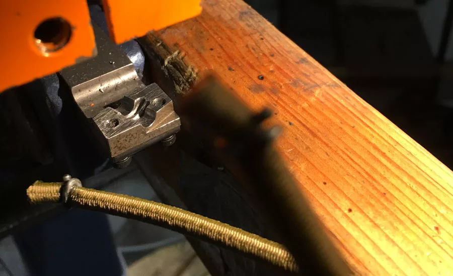 Hog-tie style staple installed onto bungee cord.