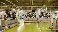 Automated guided vehicles transport motorcycles through a factory Automated guided vehicles transport motorcycles through a factory