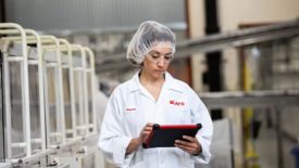 A technician uses a tablet with eFactoryPro
