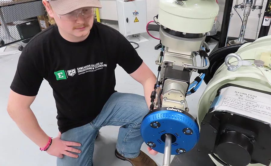student using a robotic adhesive dispenser
