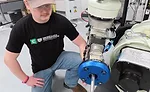 student using a robotic adhesive dispenser