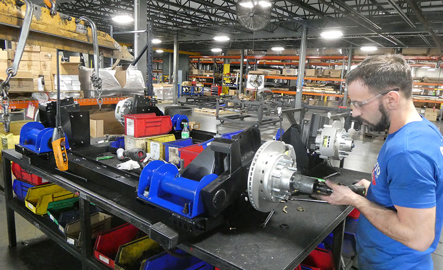 operator assembles independent suspension axles for RV trailers