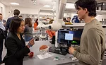 teacher assisting student with robotics project