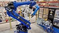 robot equipped with C-frame tooling and a servo press robot equipped with C-frame tooling and a servo press