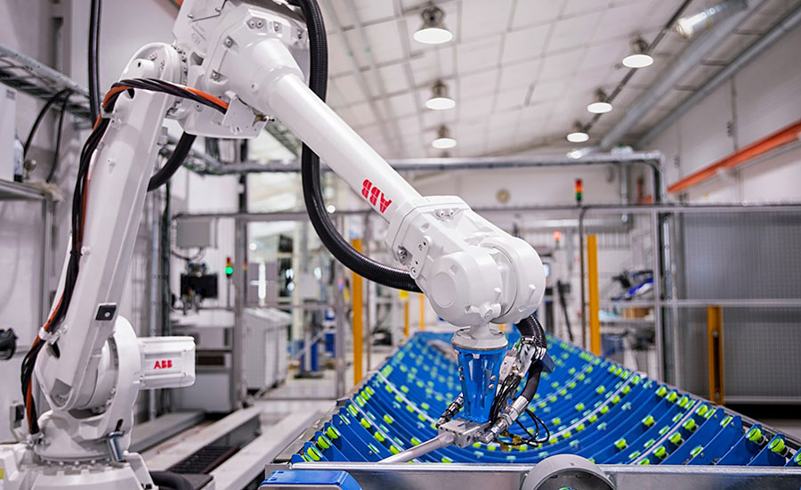 robot dispenses adhesive to bond the reflective material