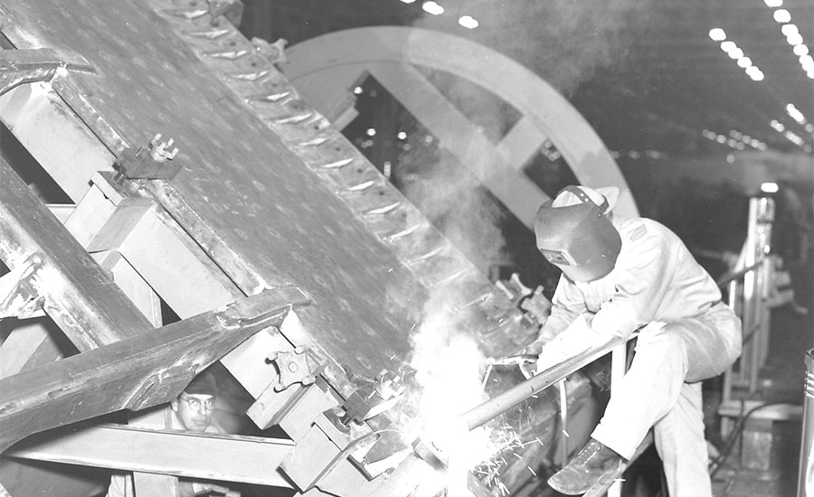 A large piece of earthmoving equipment is manually welded