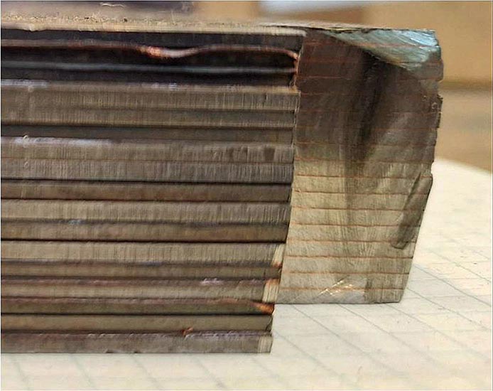 multiple layers of stainless steel and copper welded into a single solid block of material