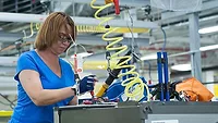 woman assembling an appliance in a factory woman assembling an appliance in a factory