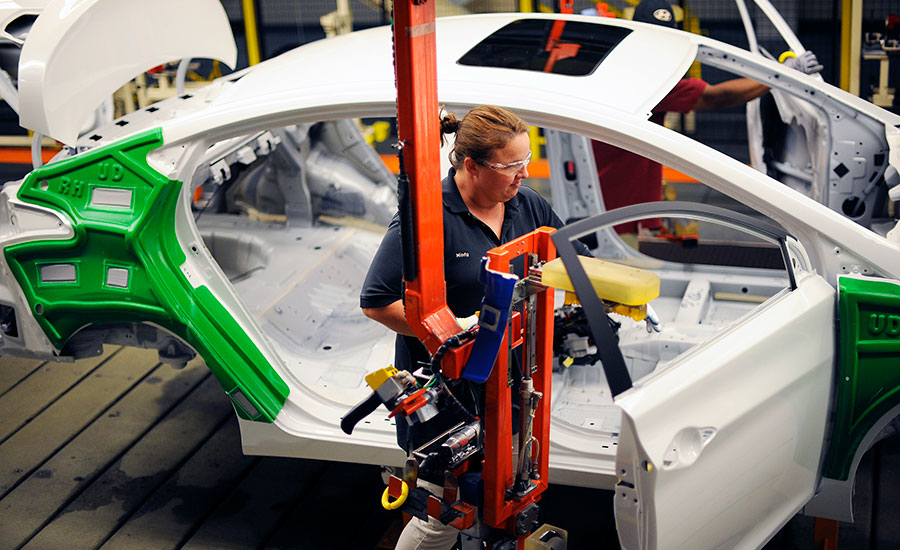 assembler working on a car door