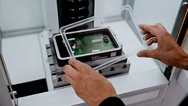 attaching a plastic cover to a metal housing