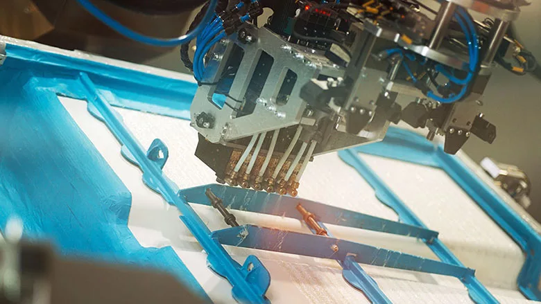 six-robot sprays hot-melt adhesive in a swirl pattern