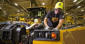 worker on a Deere assembly line
