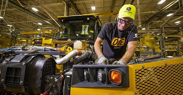 worker on a Deere assembly line