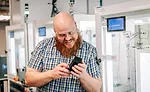 engineer inspecting a 3D-printed part