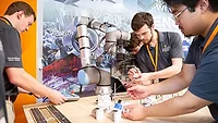 Engineers testing a six-axis collaborative robot for wire harness assembly