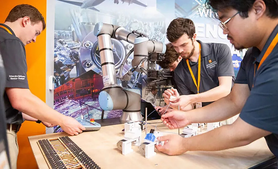 Engineers testing a six-axis collaborative robot for wire harness assembly