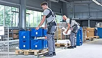 men lifting with exoskeletons