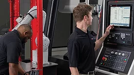 operators setting up the machine-tending cell