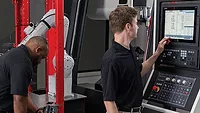 operators setting up the machine-tending cell