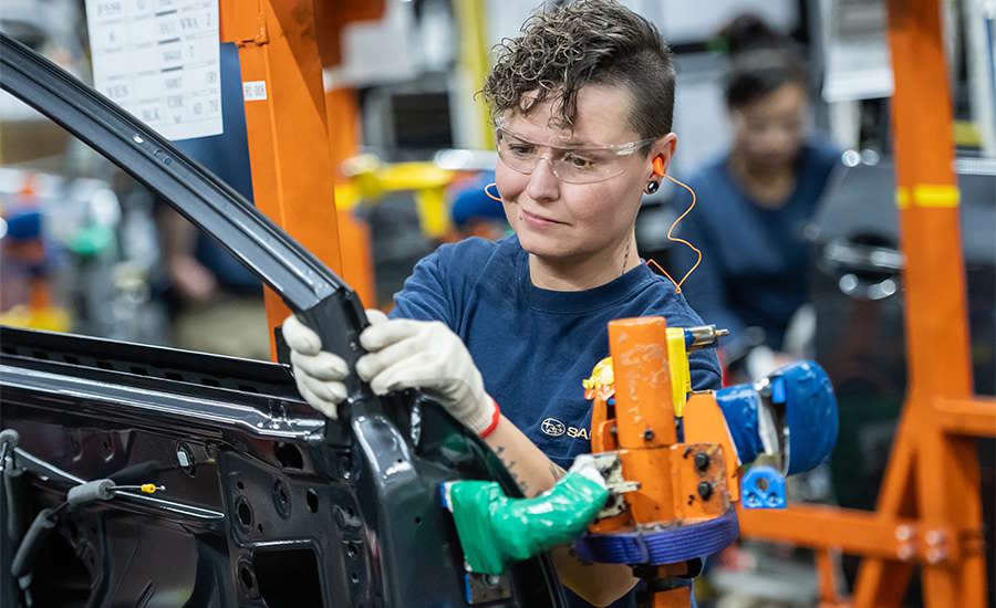 worker assembling an automobile