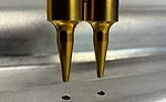 a hardened pointed tool is pressed into the top metal sheet