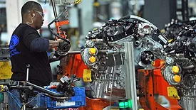 worker fastening a part to an assembly